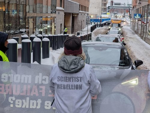 scientists block road holding banner how much more climate failure can you take