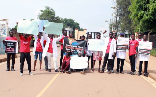 scientists holding signs blocking a road